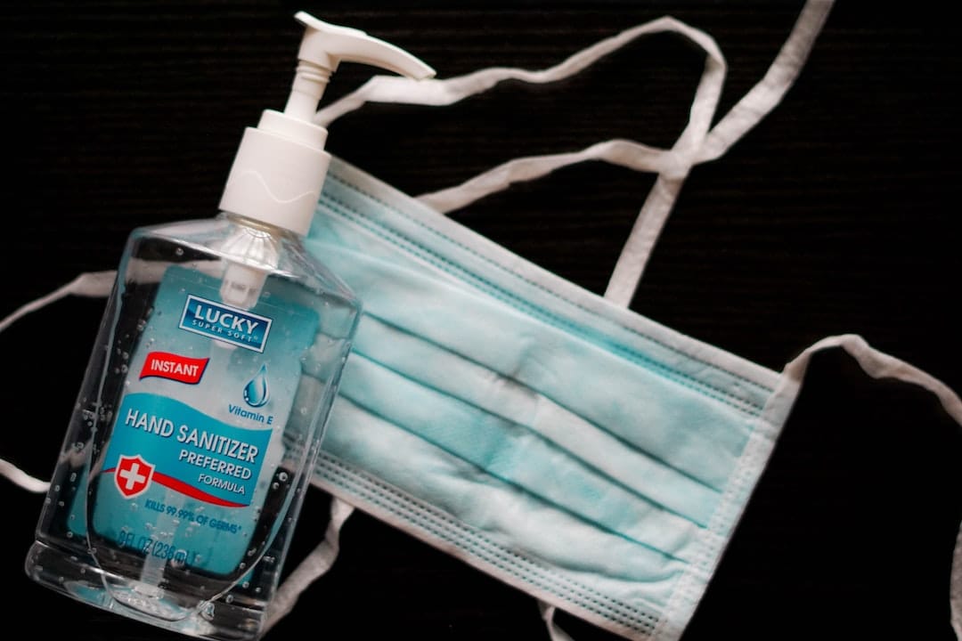 Fibromyalgia and Covid image of a face mask and some hand sanitiser.