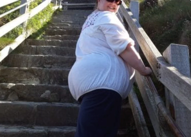 Susan climbing the steep steps at Tintagel Castle during our 2014 holiday in Cornwall.