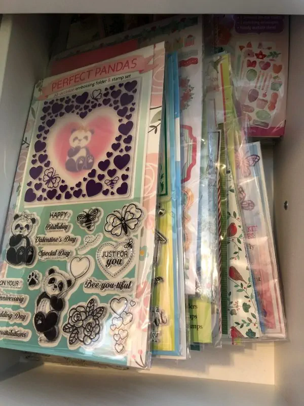 Drawer of clear stamps and dies featuring Perfect Pandas set with hearts, butterflies, and sentiments – ideal low-effort crafts for spoonies.