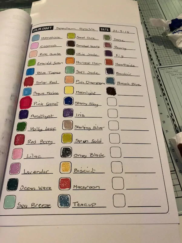 Open Spectrum Sparkle colour chart showing 32 swatched pen shades with names like Moonstone and Teacup for fibromyalgia-friendly crafting.